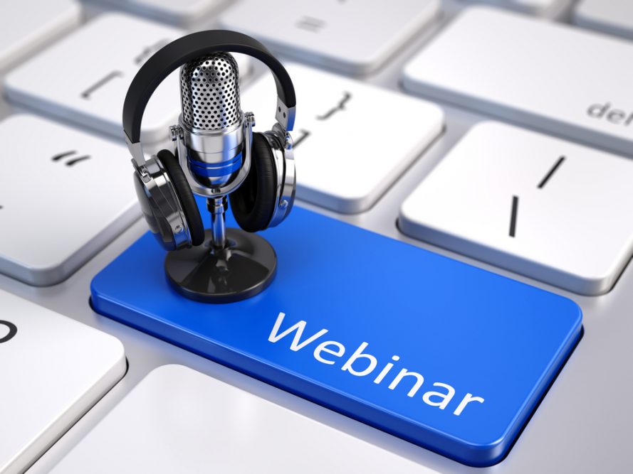 Small microphone and headphones on a laptop button named webinar.