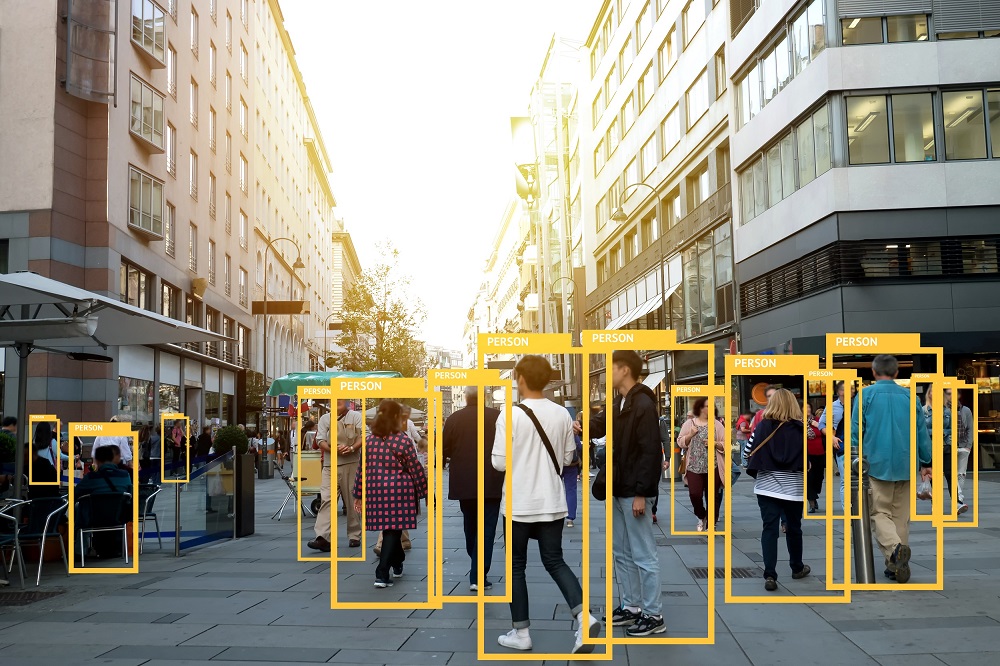 People walking on a high street, being highlighted in yellow boxes from artificial intelligence.