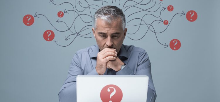 Pensive businessman at laptop.