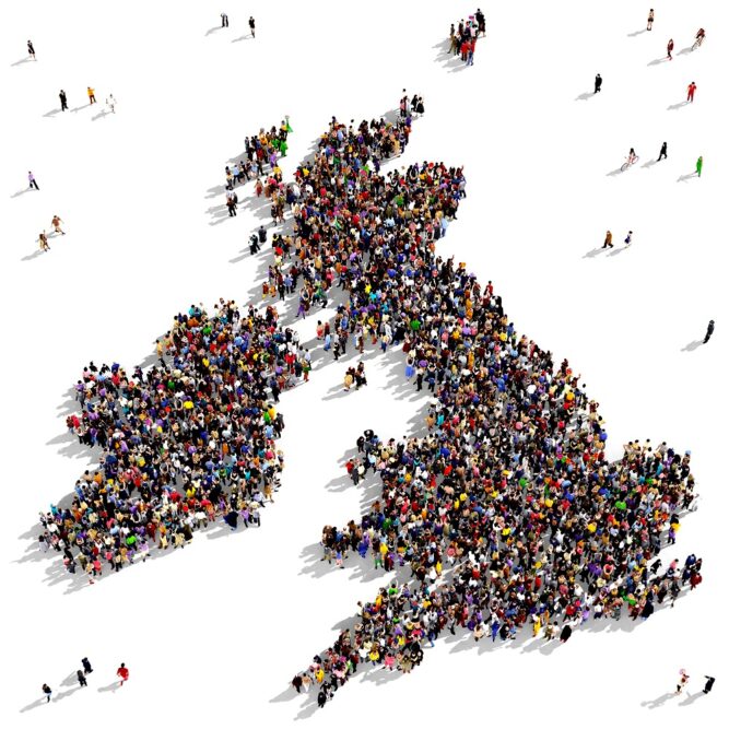 Aerial view of people on a white background, all standing together in the shape of the UK and the Republic of Ireland.