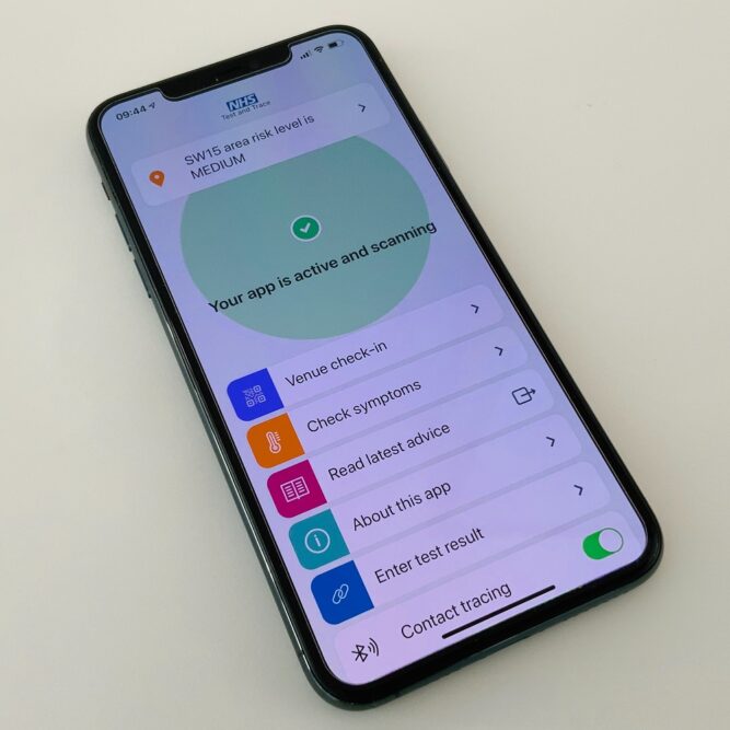 Mobile phone displaying details of NHS test and trace app.