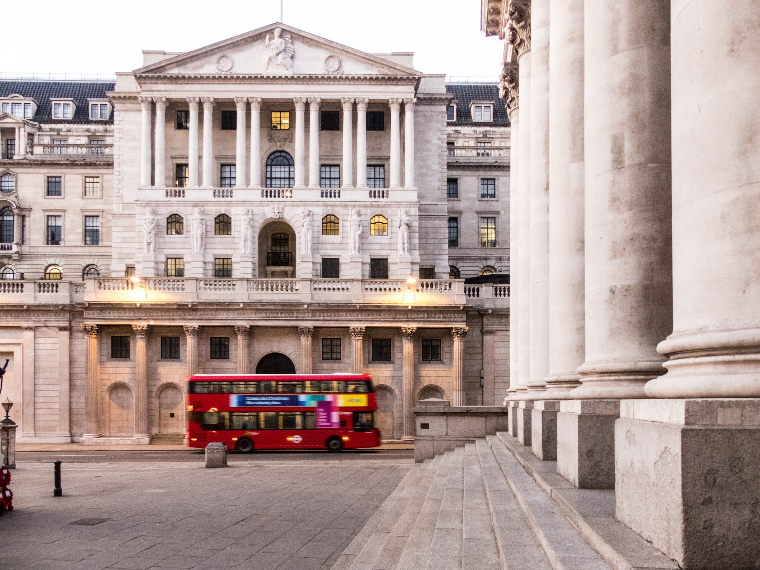 A red double decker bus is pictured in front of the Bank of England building in central London.
