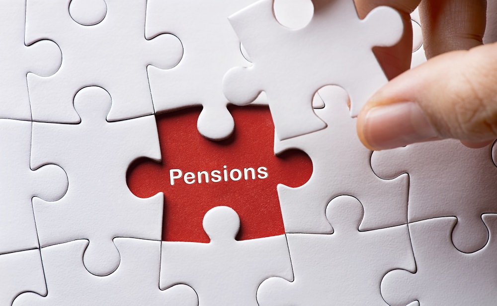 Plain white jigsaw with one piece removed. Underneath there is he word Pensions written on a red background