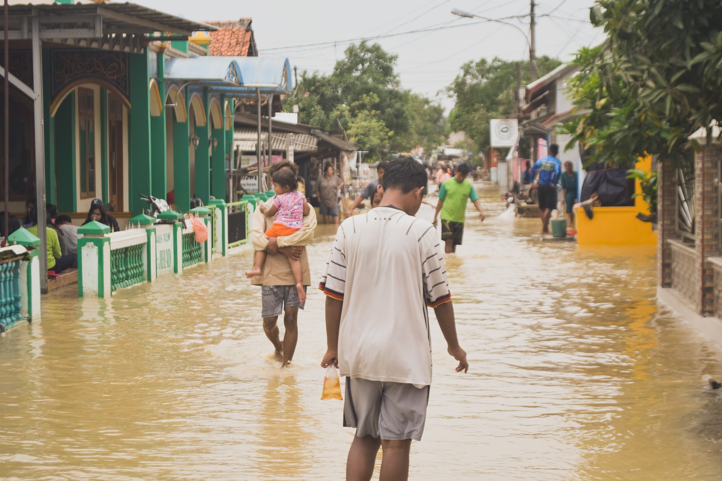 Villagers walking through flood water.