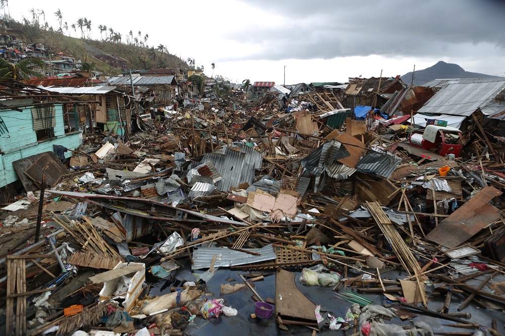 Aftermath of a typhoon shows destruction of a village.