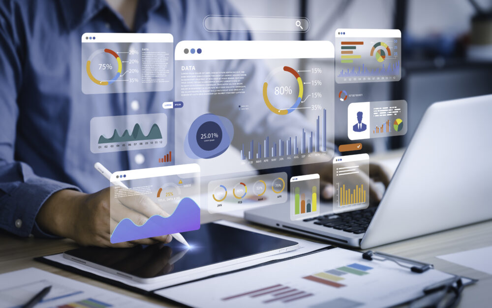 An analyst uses a computer and dashboard for data business analysis and Data Management System with KPI and metrics connected to the database for technology finance, operations, sales and marketing.