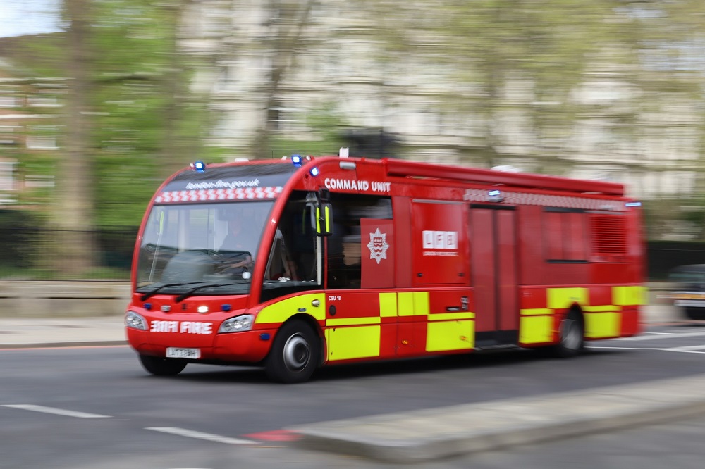 Fire engine command Unit pictured against blurred background of trees. Credit: Unsplash