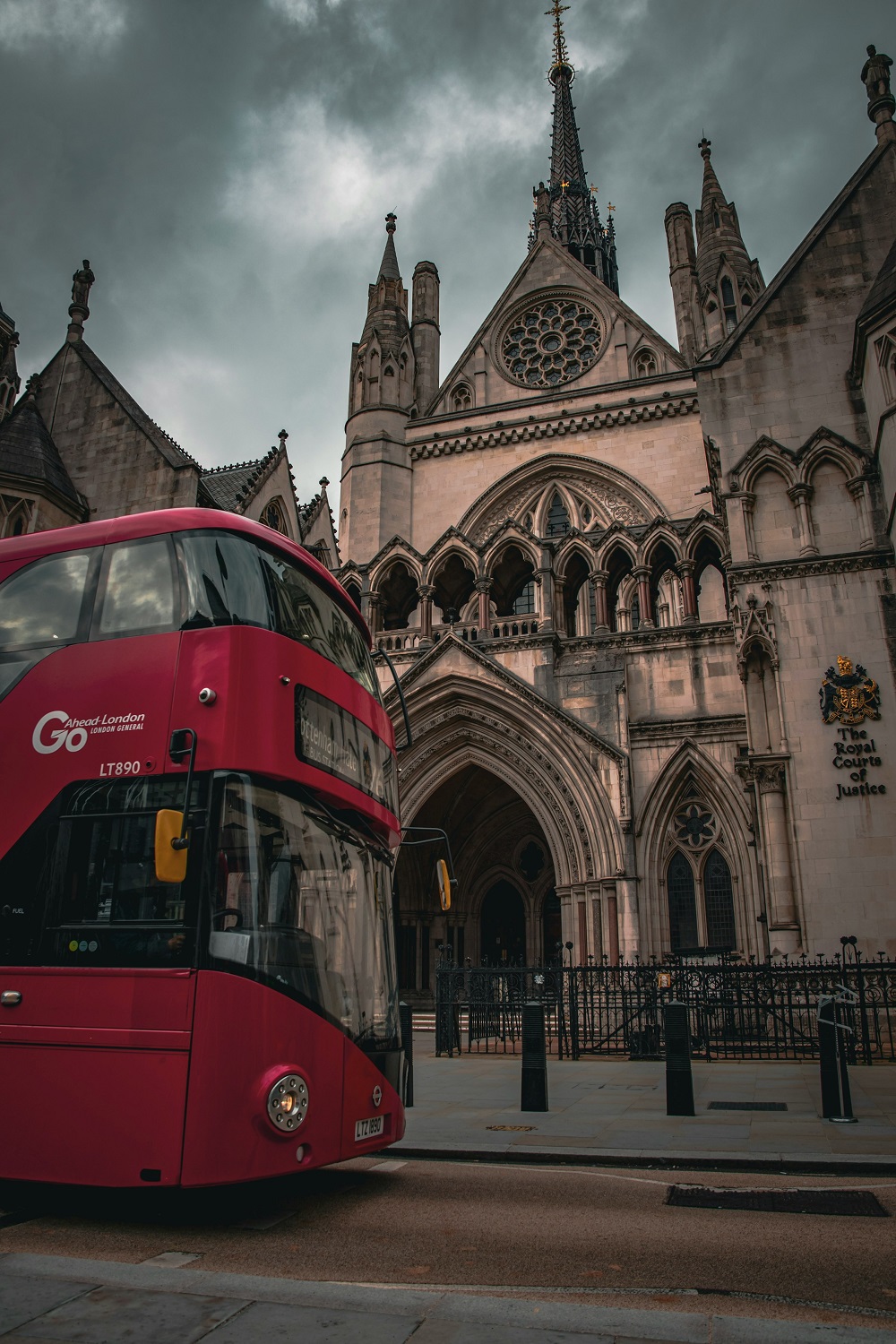 Red double decker bus outside the Royal Courts of Justice. Credit: Unsplash