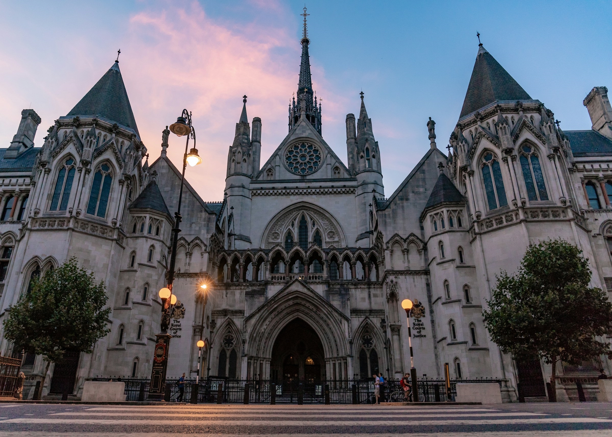 Exterior of the Royal Courts of Justice pictured at dawn, with streetlights still switched on. Credit: Unsplash