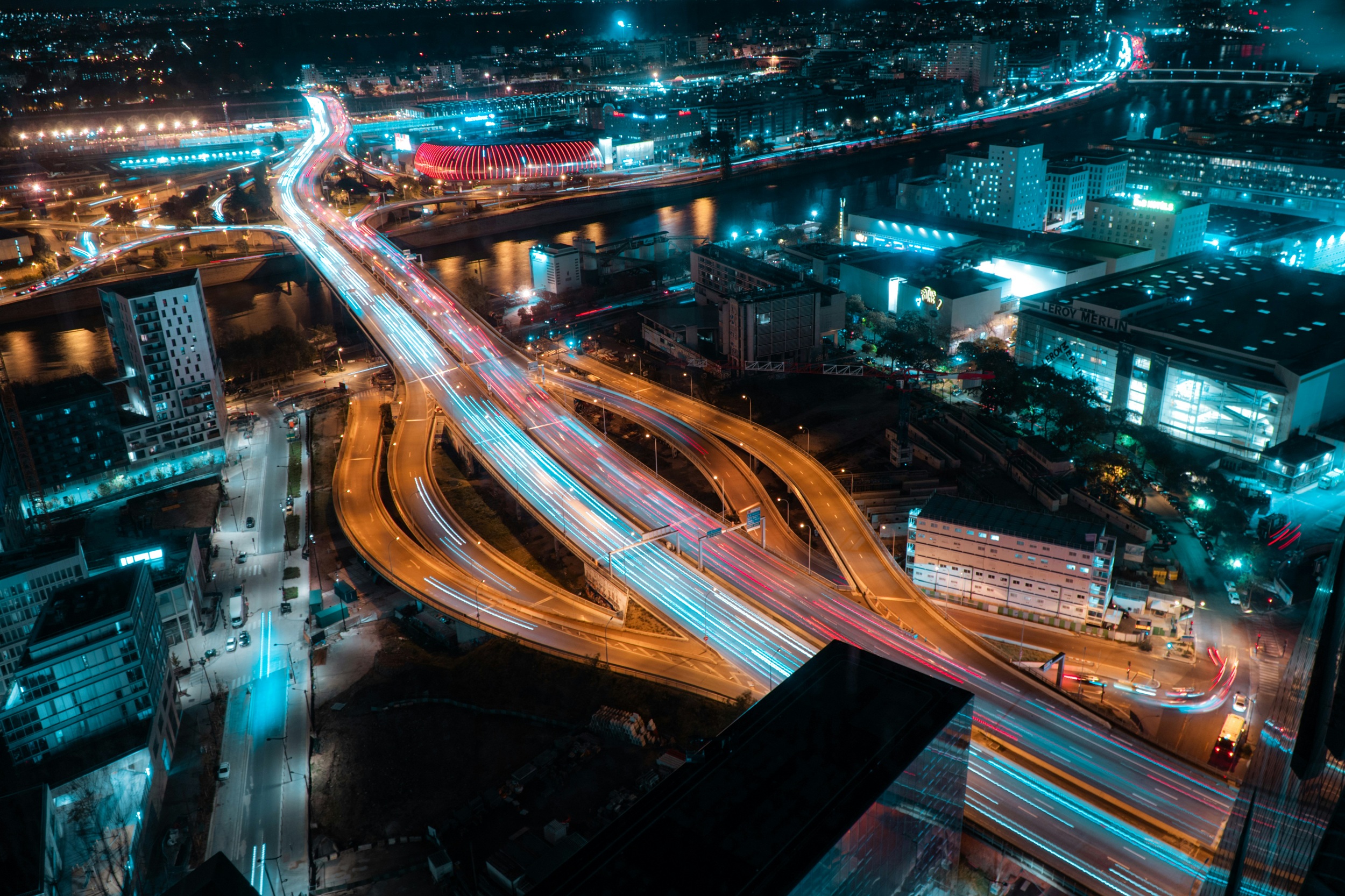Aerial view of a city at night including motorway junction. Credit: Bastien Nvs, Unsplash)